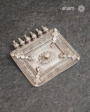 A rectangle shaped amulet representative of a home, four walls with a center courtyard. The pendant that represents shelter, stability, and divine presence within the home.&nbsp; It is a powerful symbol of family unity and protection. This pendant is hand crafted in silver.
Beautiful handcrafted tribal silver amulet pendant from a bygone area, that bring back memories and stories of that time. Wear it with a long chain or with a black thread, or layer them to create a distinct look.