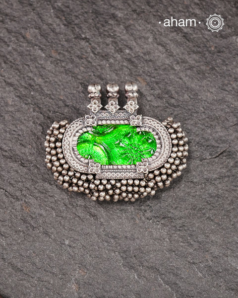 Tribal Silver pendant with beautiful green glass center and lots of tinny ghungroos tied all around. Crafted in Silver