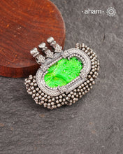 Tribal Silver pendant with beautiful green glass center and lots of tinny ghungroos tied all around. Crafted in Silver
