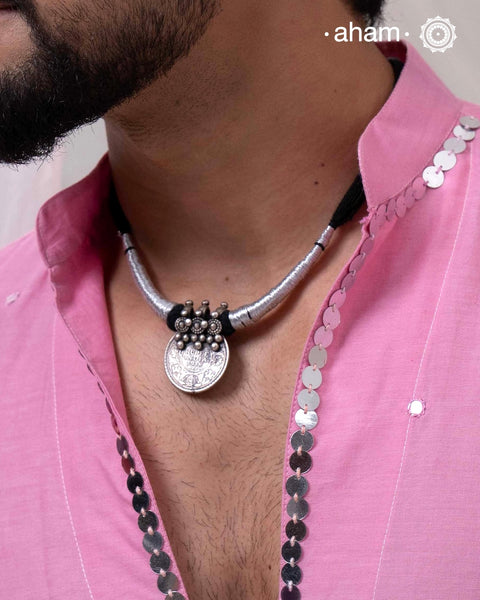 Vintage silver coin converted into pendant with fine detailing on top. Comes with traditional powai work.