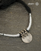 Vintage silver coin converted into pendant with fine detailing on top. Comes with traditional powai work.