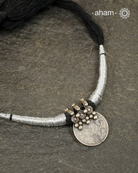 Vintage silver coin converted into pendant with fine detailing on top. Comes with traditional powai work.