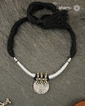 Vintage silver coin converted into pendant with fine detailing on top. Comes with traditional powai work.
