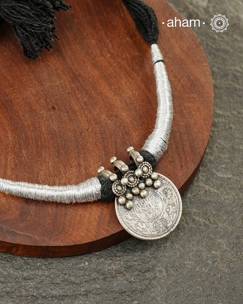 Vintage silver coin converted into pendant with fine detailing on top. Comes with traditional powai work.