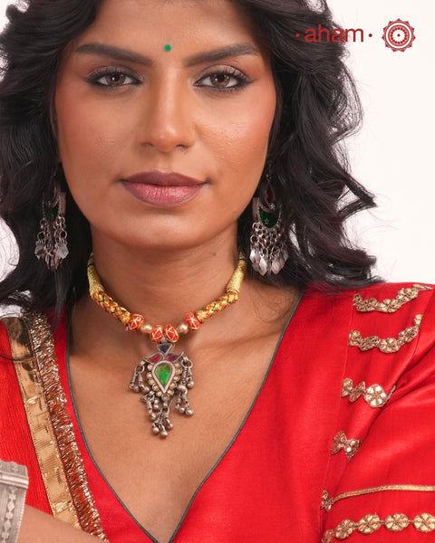 Discover this distinctive Tribal Silver Neckpiece, a handcrafted statement piece made with 80% silver. Its unique tribal-inspired design and substantial pendant bring the character of traditional Indian adornment to contemporary festive dressing. The neckpiece sits below the neck and features an adjustable cotton-thread fastening, making it a striking choice for Navratri, Garba nights and festive occasions. Style it with a chaniya choli, Bandhani, mirror-work outfit, saree or contemporary Indian wear.