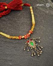 Discover this distinctive Tribal Silver Neckpiece, a handcrafted statement piece made with 80% silver. Its unique tribal-inspired design and substantial pendant bring the character of traditional Indian adornment to contemporary festive dressing. The neckpiece sits below the neck and features an adjustable cotton-thread fastening, making it a striking choice for Navratri, Garba nights and festive occasions. Style it with a chaniya choli, Bandhani, mirror-work outfit, saree or contemporary Indian wear.