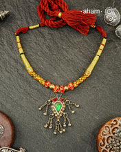 Discover this distinctive Tribal Silver Neckpiece, a handcrafted statement piece made with 80% silver. Its unique tribal-inspired design and substantial pendant bring the character of traditional Indian adornment to contemporary festive dressing. The neckpiece sits below the neck and features an adjustable cotton-thread fastening, making it a striking choice for Navratri, Garba nights and festive occasions. Style it with a chaniya choli, Bandhani, mirror-work outfit, saree or contemporary Indian wear.
