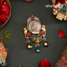 This exquisite Two Tone Silver Pendant showcases stunning krishna nakshi work accented with a vibrant emerald tumble stone and kundan highlights. Handcrafted in 92.5 silver, it is truly one of a kind. Elevate any outfit with its unique and beautiful design.

Chain not included