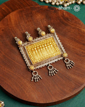 Enhance your style with the timeless elegance of the Dual Tone Silver Pendant. Handcrafted by skilled karigars in Barmer, Rajasthan, this neckpiece features traditional Bandhel work, where a thin sheet of hand beaten&nbsp;22 carat gold is set on 92.5 silver using a unique wax setting technique. A classic representation of fine Indian traditional craftsmanship.