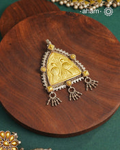 Enhance your style with the timeless elegance of the Dual Tone Silver Pendant. Handcrafted by skilled karigars in Barmer, Rajasthan, this neckpiece features traditional Bandhel work, where a thin sheet of hand beaten&nbsp;22 carat gold is set on 92.5 silver using a unique wax setting technique. A classic representation of fine Indian traditional craftsmanship.&nbsp;

Chain not included
