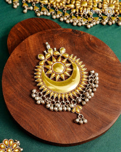 Enhance your style with the timeless elegance of the Dual Tone Silver Pendant. Handcrafted by skilled karigars in Barmer, Rajasthan, this neckpiece features traditional Bandhel work, where a thin sheet of hand beaten&nbsp;22 carat gold is set on 92.5 silver using a unique wax setting technique. A classic representation of fine Indian traditional craftsmanship.&nbsp;

Chain not included