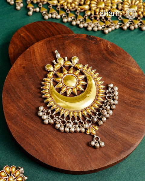 Enhance your style with the timeless elegance of the Dual Tone Silver Pendant. Handcrafted by skilled karigars in Barmer, Rajasthan, this neckpiece features traditional Bandhel work, where a thin sheet of hand beaten&nbsp;22 carat gold is set on 92.5 silver using a unique wax setting technique. A classic representation of fine Indian traditional craftsmanship.&nbsp;

Chain not included