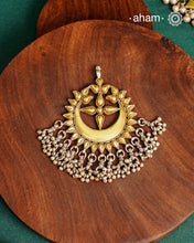 Enhance your style with the timeless elegance of the Dual Tone Silver Pendant. Handcrafted by skilled karigars in Barmer, Rajasthan, this neckpiece features traditional Bandhel work, where a thin sheet of hand beaten&nbsp;22 carat gold is set on 92.5 silver using a unique wax setting technique. A classic representation of fine Indian traditional craftsmanship.&nbsp;

Chain not included
