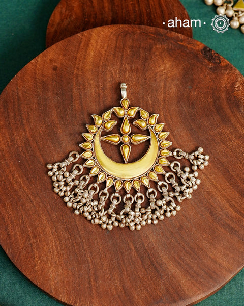Enhance your style with the timeless elegance of the Dual Tone Silver Pendant. Handcrafted by skilled karigars in Barmer, Rajasthan, this neckpiece features traditional Bandhel work, where a thin sheet of hand beaten&nbsp;22 carat gold is set on 92.5 silver using a unique wax setting technique. A classic representation of fine Indian traditional craftsmanship.&nbsp;

Chain not included