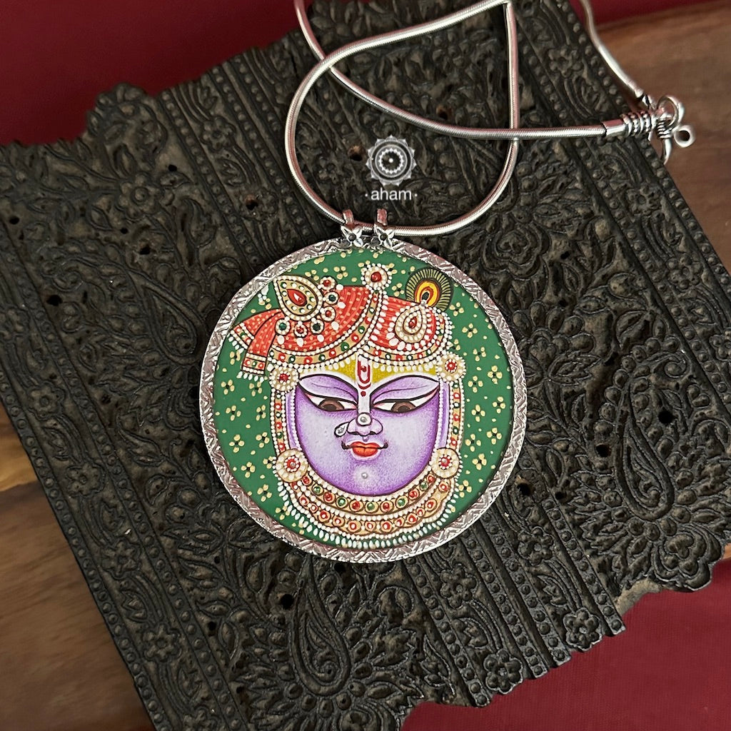 Hand painted silver Shrinathji pendant.Intricate miniature painting work done by skilful artisans to create these beautiful wearable art pieces.
(Does not include chain)