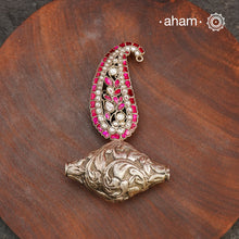 Enhance your style with the unique Ira Morpankh Silver Pendant. Featuring a stunning ambi kalki and chitai bead, this one-of-a-kind pendant can be worn with a chain or hasli, adding elegance to any outfit. Upgrade your look with this exquisite piece.(Does not include chain)