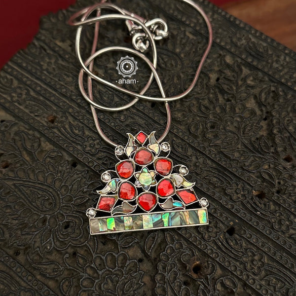 Beautifuful Ira silver pendant with Mother of pearl and red kundan highlights. a beautiful unique piece. Wear it with a chain or a silver Hasli of your choice.