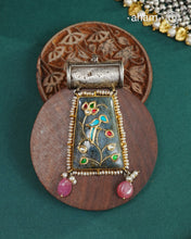 Crafted from 92.5 sterling silver, the Ira Stone Silver Pendant showcases a captivating labradorite stone enhanced with intricate silver inlay detailing. This sophisticated piece combines a vintage silver top with a natural stone base, creating a distinctive aesthetic that bridges classic craftsmanship and contemporary elegance. Versatile in styling, wear it suspended from a delicate chain or paired with a traditional hasli for an authentic touch. A timeless addition to any jewellery collection that celebra