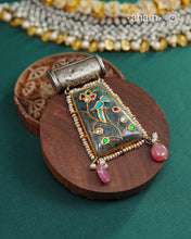 Crafted from 92.5 sterling silver, the Ira Stone Silver Pendant showcases a captivating labradorite stone enhanced with intricate silver inlay detailing. This sophisticated piece combines a vintage silver top with a natural stone base, creating a distinctive aesthetic that bridges classic craftsmanship and contemporary elegance. Versatile in styling, wear it suspended from a delicate chain or paired with a traditional hasli for an authentic touch. A timeless addition to any jewellery collection that celebra