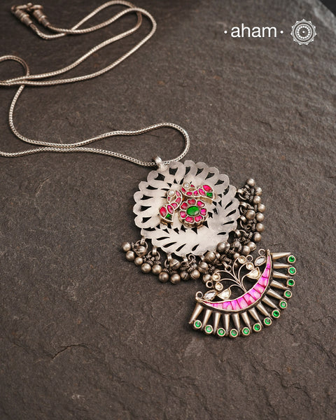 One of a kind neckpiece with a cutwork pendant, ghungroos, and beautiful kundan highlight. Comes with a long chain. Crafted in silver.