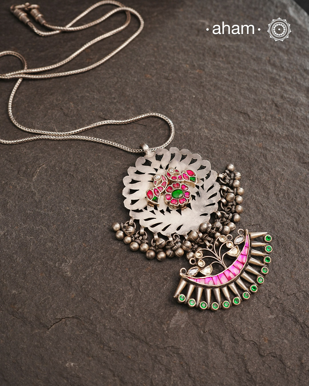 One of a kind neckpiece with a cutwork pendant, ghungroos, and beautiful kundan highlight. Comes with a long chain. Crafted in silver.