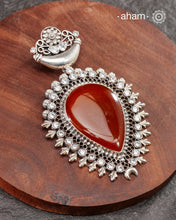 Silver Pendant with a large carnelian stone center and zircon stones around it.&nbsp;
A big bold pendant to make a statement. Wear it with a long chain or thread.&nbsp;

(Does not include chain)