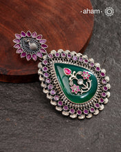 Green Quartz stone with Silver floral work on it, Set in a silver frame with kemp work and a beautiful kemp stone studded peacock on the top. Crafted in 92.5 silver. A beautiful statement piece.