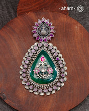 Green Quartz stone with Silver floral work on it, Set in a silver frame with kemp work and a beautiful kemp stone studded peacock on the top. Crafted in 92.5 silver. A beautiful statement piece.