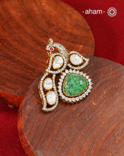 Inspired by the regal beauty of the peacock, this pendant is adorned with shimmering moissanite stones and highlighted by a textured green stone at its heart. Crafted in 92.5 silver and finished with gold polish, it reflects the charm of traditional artistry while remaining effortlessly wearable.