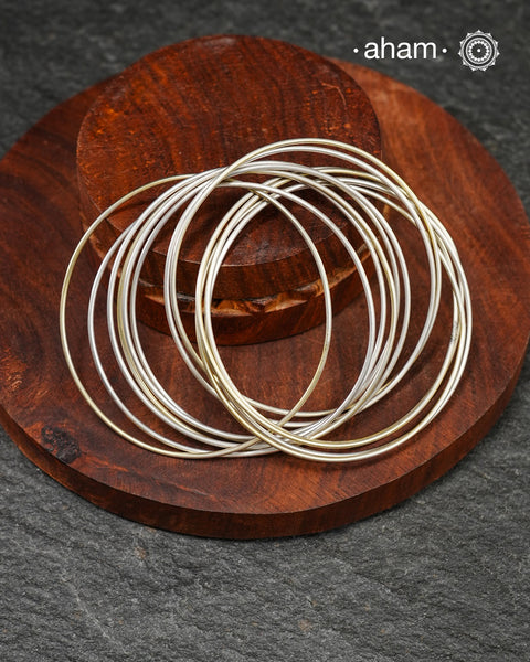A cluster of plain silver bangles. These are so much fun to wear. gives the illusion of a stack. Crafted in 92.5 silver&nbsp;