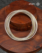 A cluster of plain silver bangles. These are so much fun to wear. gives the illusion of a stack. Crafted in 92.5 silver&nbsp;