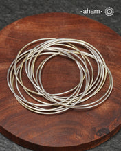 A cluster of plain silver bangles. These are so much fun to wear. gives the illusion of a stack. Crafted in 92.5 silver&nbsp;