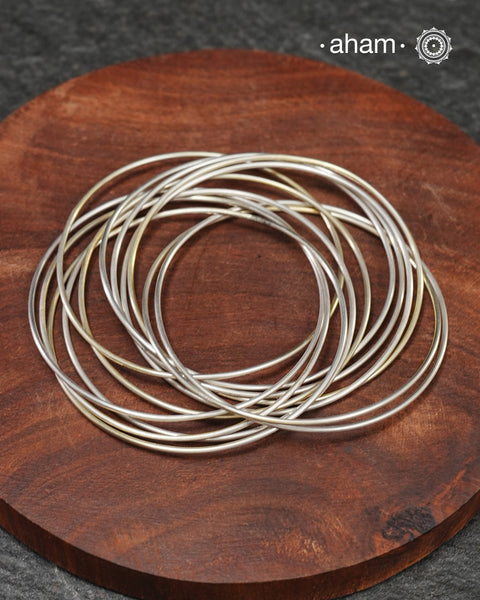 A cluster of plain silver bangles. These are so much fun to wear. gives the illusion of a stack. Crafted in 92.5 silver&nbsp;
