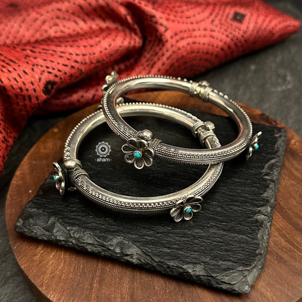 Mewad kada with beautiful Rava work and turquoise flower highlights. Handcrafted in 92.5 sterling silver.Everyday staple pieces which can be teamed with any outfit of your choice. The price is for one piece kada only.