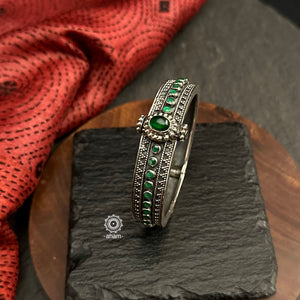 Mewad kada with beautiful Rava and green stone highlights.Handcrafted in 92.5 sterling silver in Rajasthan. Everyday staple pieces which can be teamed with any outfit of your choice.