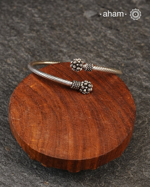 Handcrafted twist and wear bracelets in 92.5 sterling silver with beautiful flower motifs. Statement accessory which look great paired with your watches or even by itself.