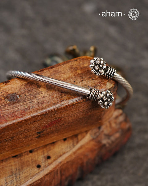 Handcrafted twist and wear bracelets in 92.5 sterling silver with beautiful flower motifs. Statement accessory which look great paired with your watches or even by itself.
