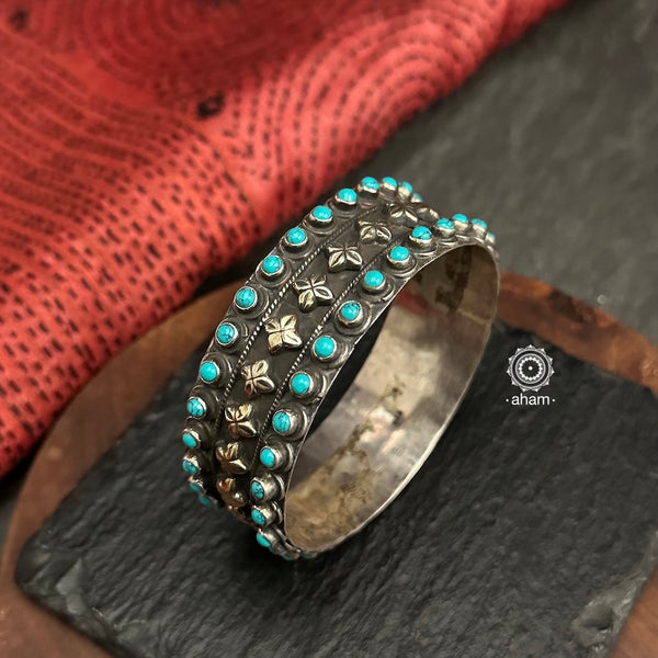 92.5 sterling silver kada with turquoise coloured stone highlights.