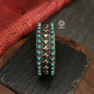 92.5 sterling silver kada with turquoise coloured stone highlights.