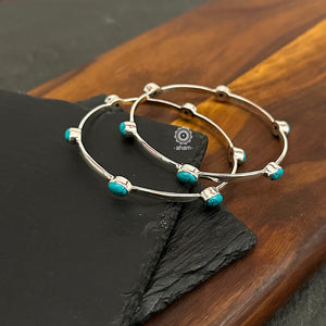 Handcrafted Summer Love bangles in 92.5 sterling silver with turquoise coloured stone highlights. Perfect everyday wear you can stack them or wear them alone.  Comes in a pair (2 bangles)