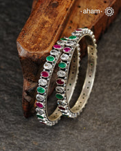 Handcrafted Summer Love bangles in 92.5 sterling silver with green and maroon stone setting. Perfect for everyday wear, you can stack them or wear them alone.