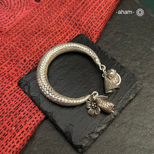 Up your wrist game with the A.M P.M Silver bracelet!The charm bracelet, complete with a beautiful weave pattern inspired by Thai craftsmanship. Perfect for adding a playful touch to any outfit.