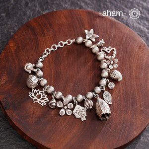 Up your wrist game with the A.M P.M Silver bracelet!
15 beautiful distinct charms all crafted in 92.5 silver come together to make this piece . Whether worn at day or night, this bracelet is Perfect for adding a playful touch to any outfit.

The price is for one piece only.