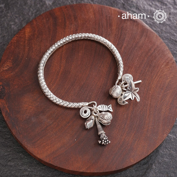 Up your wrist game with the A.M P.M Silver bracelet!The charm bracelet, complete with a beautiful weave pattern inspired by Thai craftsmanship. Perfect for adding a playful touch to any outfit.