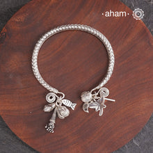 Up your wrist game with the A.M P.M Silver bracelet!The charm bracelet, complete with a beautiful weave pattern inspired by Thai craftsmanship. Perfect for adding a playful touch to any outfit.