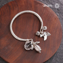 Up your wrist game with the A.M P.M Silver bracelet!The charm bracelet, complete with a beautiful weave pattern inspired by Thai craftsmanship. Perfect for adding a playful touch to any outfit.