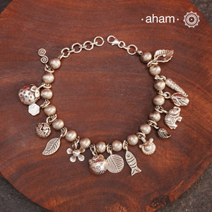 Up your wrist game with the A.M P.M Silver bracelet!
15 beautiful distinct charms all crafted in 92.5 silver come together to make this piece . Whether worn at day or night, this bracelet is Perfect for adding a playful touch to any outfit.