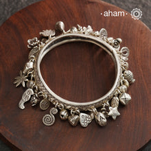 A beautiful A.M P.M Charm silver bangle Crafted in 92.5 silver with lots and lots of charms.
The price is for one piece only.