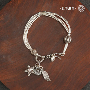 Up your wrist game with the A.M P.M Silver bracelet! Beautiful distinct charms all crafted in 92.5 silver come together to make this piece. Whether worn at day or night, this bracelet is perfect for adding a playful touch to any outfit. The price is for one piece only.