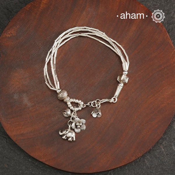 Up your wrist game with the A.M P.M Silver bracelet! Beautiful distinct charms all crafted in 92.5 silver come together to make this piece. Whether worn at day or night, this bracelet is perfect for adding a playful touch to any outfit.The price is for one piece only.